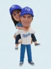 Wedding bobbleheads bride on the back of groom